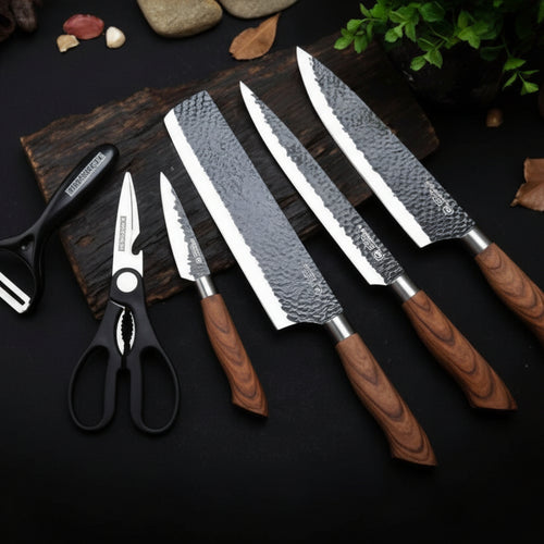 Set of knives with wooden handles on a dark surface