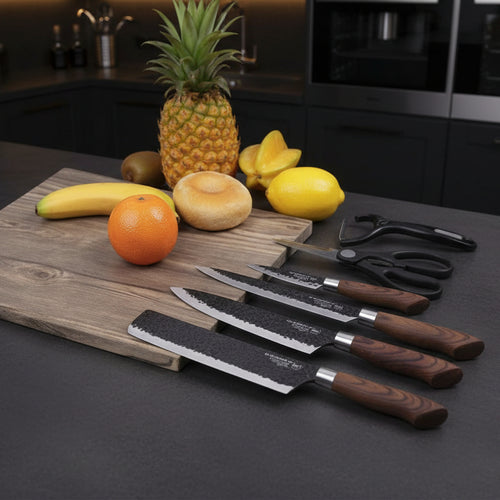 Set of knives on a wooden cutting board with fruits and scissors