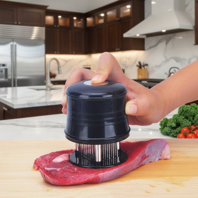 Hand using a meat tenderizer on a piece of meat with a colorful background of vegetables.
